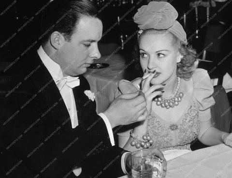 Betty Grable gets her cigarette lit 8b20-8911