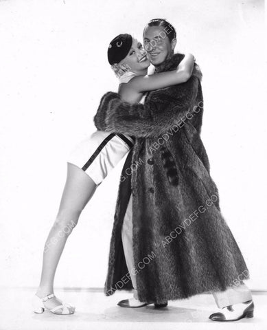 Betty Grable cute in shorts hugs guy in fur coat 8b20-8923