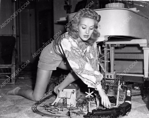 Betty Grable sets up the model trains for a little playtime 8b20-8935