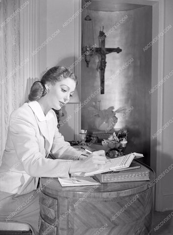 Loretta Young writing at desk at home lyoung-53