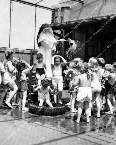 crp-15366 1950 St Ignatius Loyola Nursery NYC cools off kids w hose on roof playground crp-15366