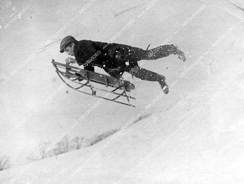 crp-15392 1921 Franklin Park Boston youngster flies through air on toboggan sled in the snow crp-15392
