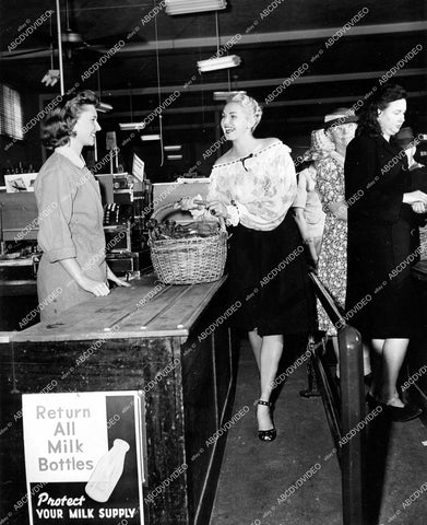 crp-18108 1944 Adele Jergens helps WWII scrap drive effort returns milk bottles crp-18108
