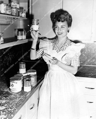 crp-18509 circa 1943 Janet Blair checks kitchen and canned goods inventory crp-18509