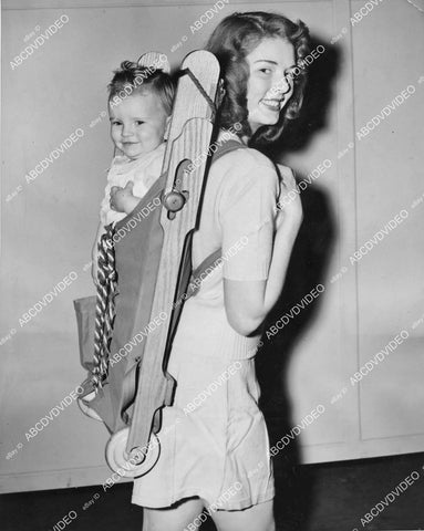 crp-02549 1943 Libby Lee w Joyce Ferguson demonstrates fold up stroller / baby-back-pack papoose style crp-02549