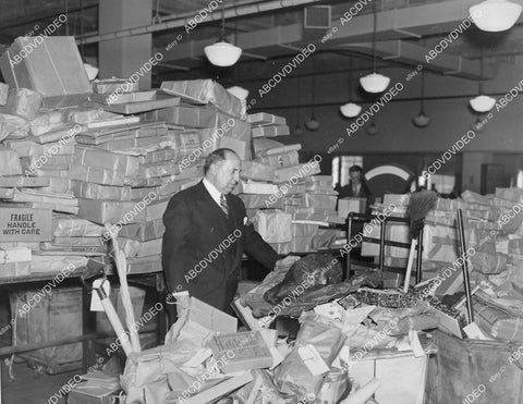 crp-00876 1936 8,000 Christmas Parcels Went Astray Postmaster Albert Goldman looks over mess crp-00876
